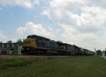 CSX 7379 leads a long train thru town